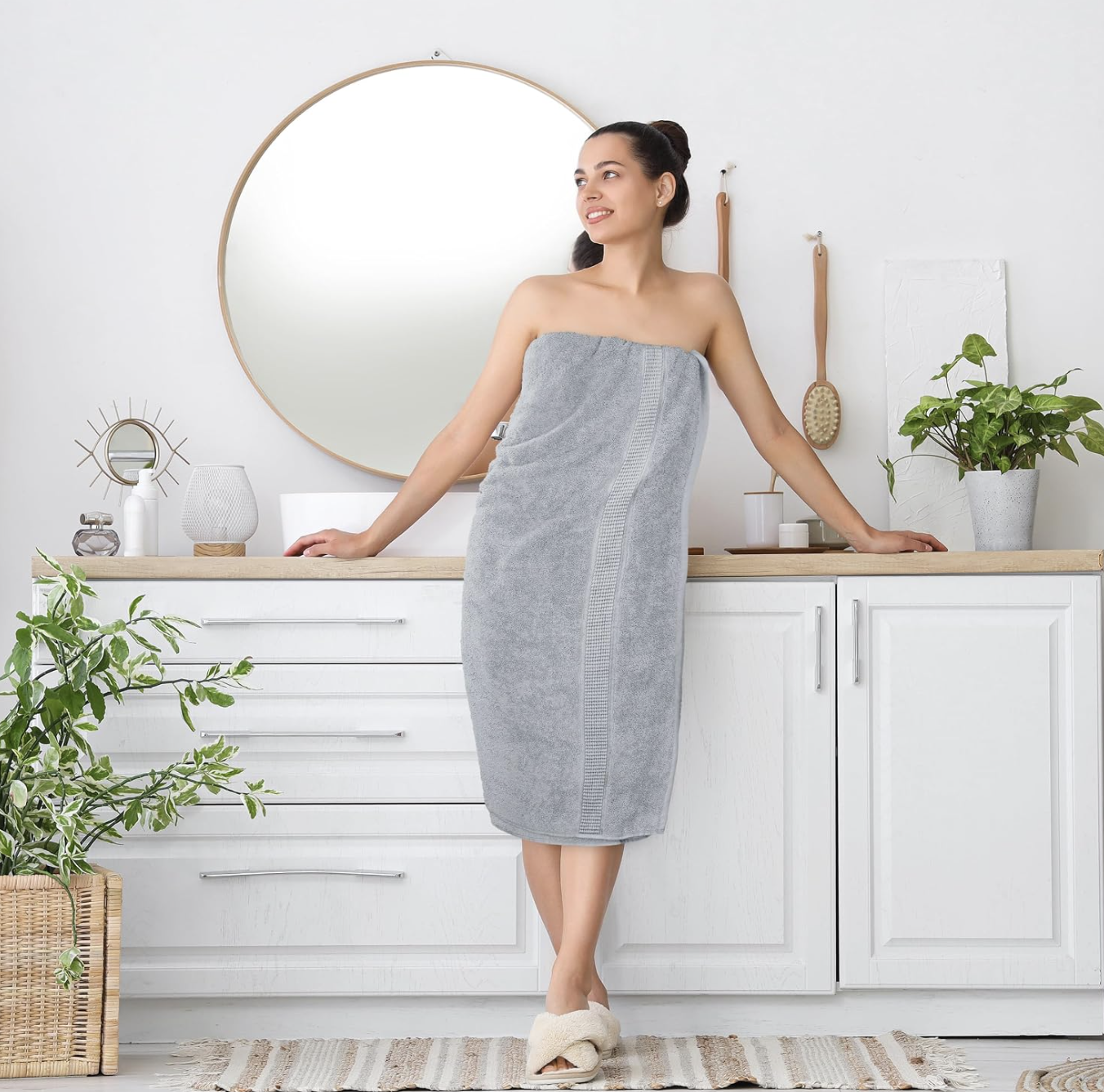 A woman wrapped in a soft bath towel in a bright modern bathroom
